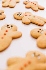 cookies in the shape of ginger men with a vampire face prepared for Halloween lie on a pink background. Halloween background
