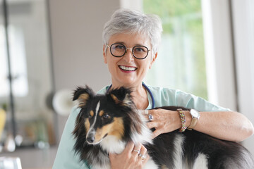 Cheerful veterinarian woman with dog