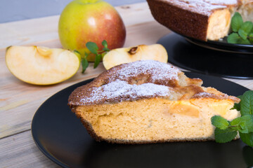 Charlotte, Apple pie with mint sprigs, Apple, Apple slices in a black plate on a wooden table, copy space, close-up, photos,
