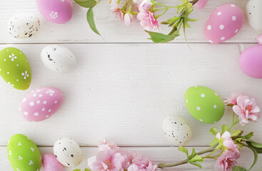 easter eggs and cherry blossom flowers on white background