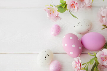 easter eggs and cherry blossom flowers on white background