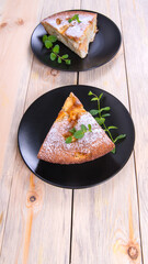 Charlotte, Apple pie with mint sprigs in a black plate on a wooden table, copy space, close-up, photos,