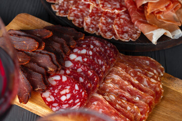 Wooden platter with meat cuts close up