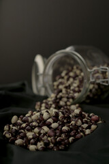 jar of beans and legumes on black background