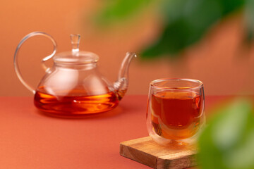 Glass teapot and cup with black tea