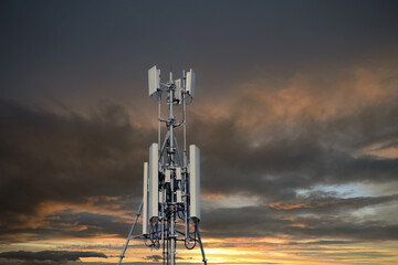 4G and 5G cellular. Macro Base Station or Base Transceiver Station. Telecommunication tower. Wireless Communication Antenna Transmitter at dark sunset background.