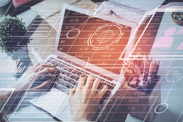 Obraz premium Multi exposure of technology hologram with man working on computer background. Concept of big data.