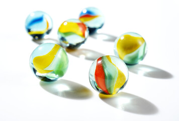 colorful marbles on white background - 387361078