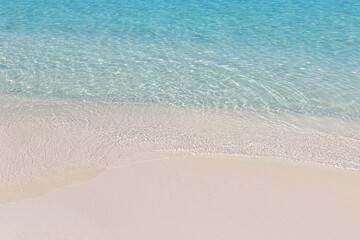 Crystal clear water and sand on beach of Ksamil in Albania, border between the Adriatic and Ionian seas