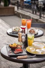 lunch dishes and cocktails served on the table street food cafe summer outside