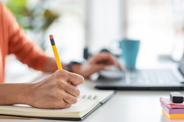Join Video conference call from home.asian woman writing plan collaboration with colleagues while...