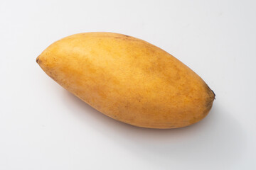 Ripe mango on a white background, tropical fruit.