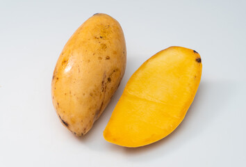 Disease mango on a white background, a black spot on the surface of the mango is often referred to as anthracnose.