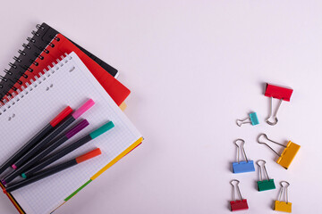 different stationary items of various colours on light surface.
