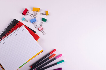 different stationary items of various colours on light surface.