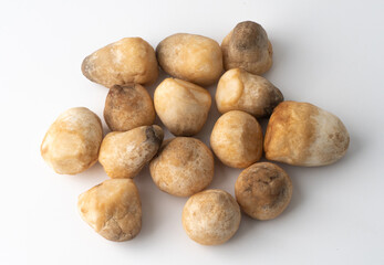 Top view of pile of straw mushroom on a white background.