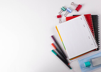 different stationary items of various colours on light surface.