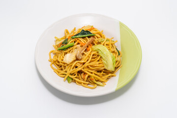 Chinese-Styled Fried Noodle on plate isolated on a white background, Vegetarian Festival.