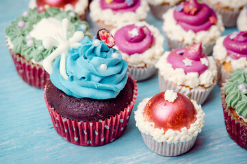 Very nice composition of cupcakes and cakepops with deocrations, colorful, blue background