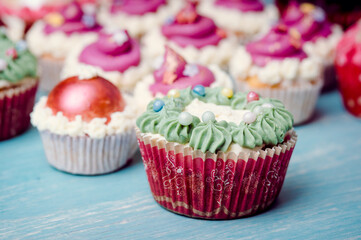 Very nice composition of cupcakes and cakepops with deocrations, colorful, blue background