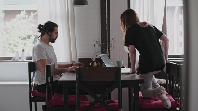 A Young Couple In Love Working Together On A Computer, Safely From Home.