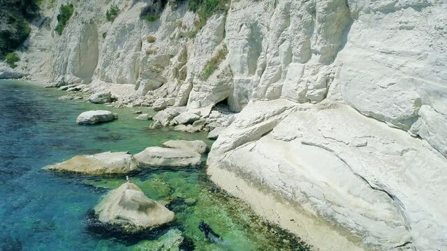 Snorkeling in Portonovo bay near Sirolo in blue crystal sea water under the steep cliffs During the exploration underwater with snorkel diver&rsquo;s mask and flipper a seagulls were flying over cliffs