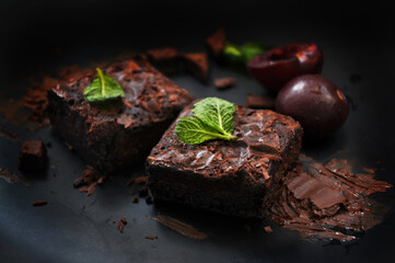 Messy Fudge Brownies with Chocolate on Dark Background