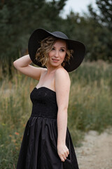 Hats fashion. A close up portrait of a charming young woman in a fashionable black hat