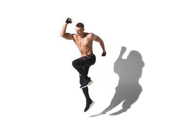 Running, jumping high. Stylish young male athlete on white studio background, portrait with shadows. Sportive fit model in motion and action. Body building, healthy lifestyle, style concept.