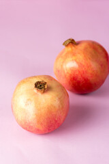 Ripe Pomegranate Fruit on Pink Background Vertical