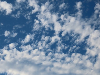 Beautiful background of blue sky and white clouds in autumn in Israel close-up.