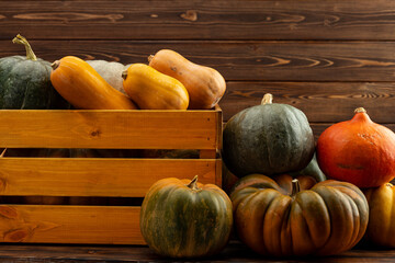 Pile of pumpkins in a wooden box
