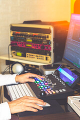 music producer hands editing and mixing audio tracks on control surface. music production concept