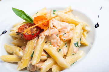 Traditional Italian pasta penne with salmon and creamy sauce.