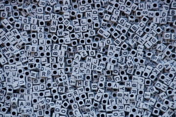 Cluster of white cube-shaped beads with black letters.