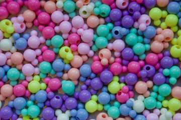 Fototapeta na wymiar Cluster of coloured spheric-shaped beads.