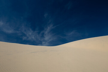 Fototapeta na wymiar sand dunes and sky with different clouds