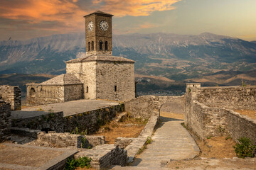 Sunset over clock tower and fortress at Gjirokaster castle, Albania - obrazy, fototapety, plakaty