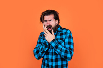 bearded hipster suffering from toothache has pain and dental problems, stomatology medicine