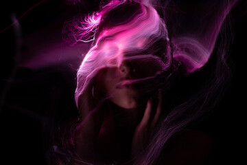 Abstract photography in the style of light painting. girl on a black background	
