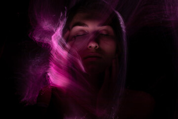 Abstract photography in the style of light painting. girl on a black background	
