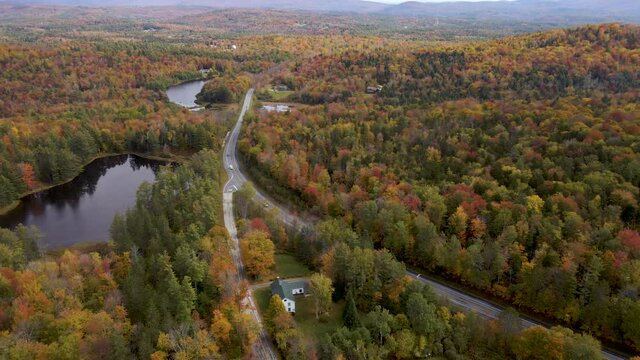 Epic Aerial View above New England Interstate with Beautiful Fall Color Forest