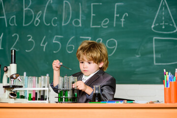 biology science. science experiments with microscope in lab. school kid scientist studying science. Little boy is make science experiments. little boy at lesson. Back to school. Scientific researches