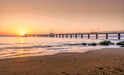 sunrise on the beach and the bridge