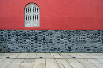 The red walls and windows of the temple