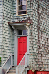 Typical Victorian architecture New England style cottage or wood house facade with wooden shingles