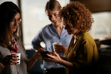 Colleagues in office talking and having fun. Friends working together.