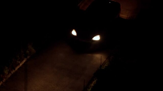 The car leaves the yard in the dark