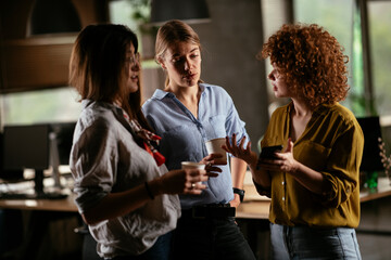 Colleagues in office talking and having fun. Friends working together.