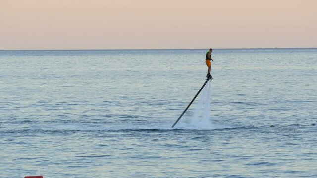 Flyboarder is engaged in Flyboarding on the seashore, active sport in Adriatic Sea in the Bay of Kotor, Montenegro.